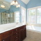 A view of a master bathroom vanity and tub set up.
