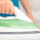 a white and green clothes iron