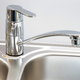 a silver kitchen sink and faucet