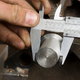 A Vernier caliper being used to measure an outside diameter.