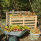 compost pile with containers of organic material next to it