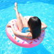 a girl in an inflatable toy in an above ground pool