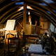 A darkly-lit attic full of antique junk.