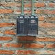 electrical boxes mounted to a brick wall