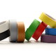 Many different colored rolls of electrical tape sit against a white background.