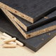 ready-to-put-together black particleboard furniture pieces with pegs