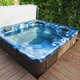 A hot tub outside on a wooden deck.