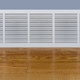 baseboard heater in a room with wood floor