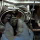 distributor in an engine with a gloved hand