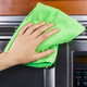 A stainless steel microwave and a cleaning rag.