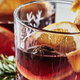red wassail drinks with sliced citrus fruit and cinnamon