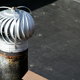 A turbine vent on top of a flat roof.