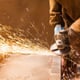 using an angle grinder with flying sparks
