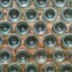 A wall made of glass bottles, filled between with cement.