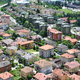 suburban town with residential housing are in the front and farm and business zones in the back