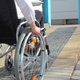 woman heading up brick wheelchair ramp