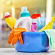 Colorful cleaning supplies in a bucket.