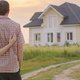 couple looking at a house on a dirt road