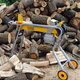 log splitter with pile of wood behind