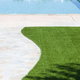 Pathway to a pool with surrounding artificial turf