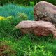 large rocks in grassy landscaping