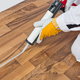 Silicone glue is applied on home flooring.
