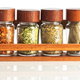 A magnetic spice rack in a kitchen. 