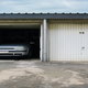 car in a garage with a flat roof