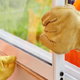 gloved hands installing new window