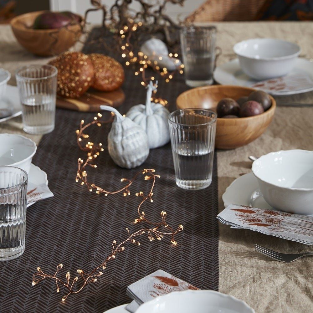 Simple, tasteful dishware and dining room table decor featured in IKEA's Fall 2021 Höstkvall collection.