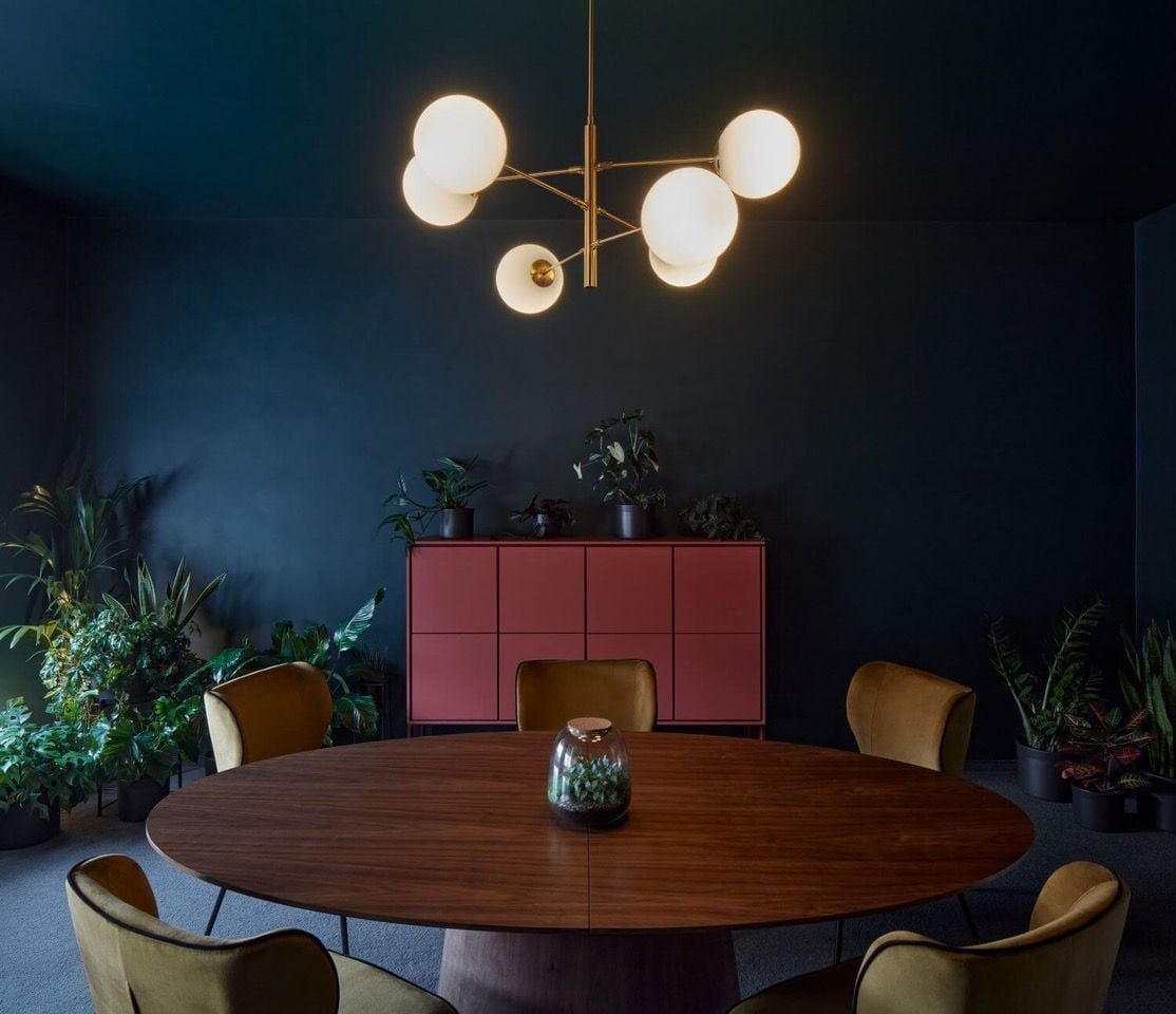 Dark blue walls and tasteful furniture picks bring a calm, pensive vibe to the Poetizer offices.