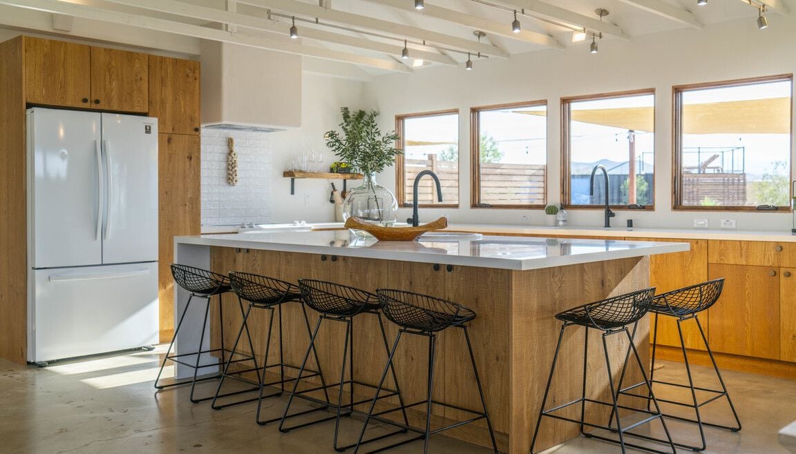 Breezy minimalist kitchen with a large quartz island at 636 Valencia Drive in Joshua Tree.