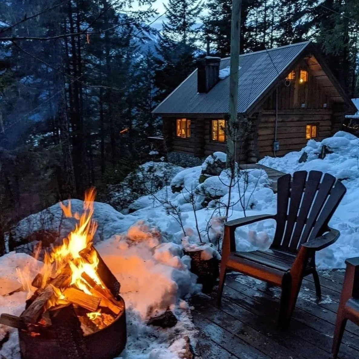 Cozy outdoor fire pit surrounded by a thick blanket of snow.