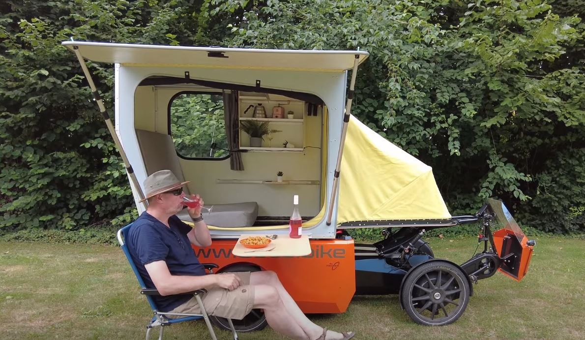 Fold-out table and canopy on the side of the GoLo GoCamp's RV module allow you to eat and work outdoors.