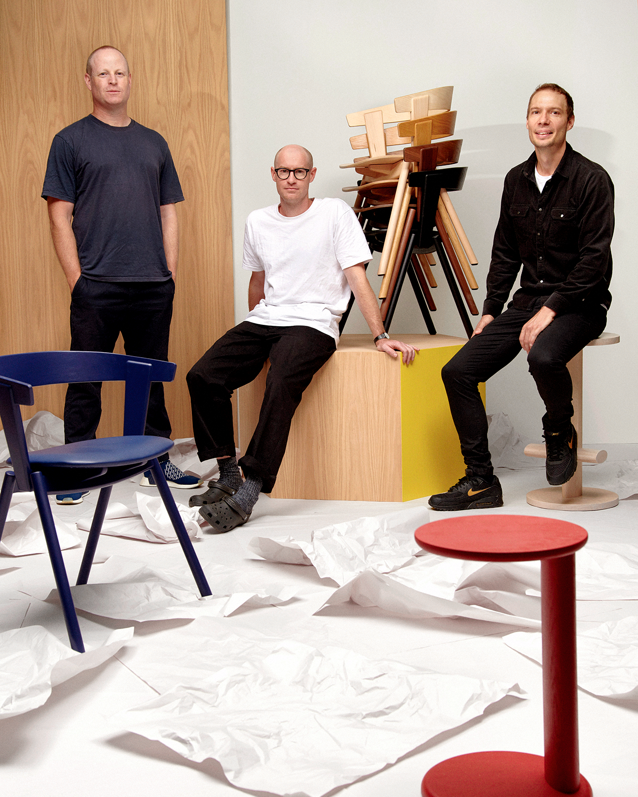 The Oku Space design team proudly poses alongside pieces from their debut furniture collection.