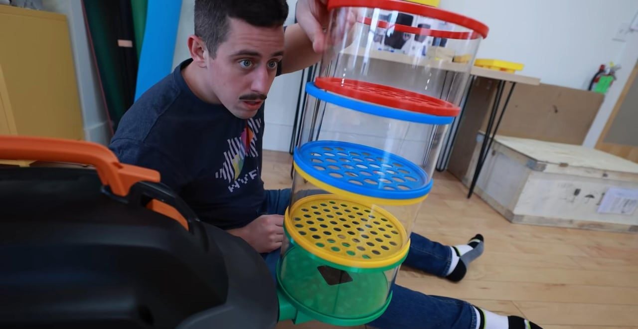 Youtuber Matty Bendetto examines his innovative LEGO-organizing vacuum.