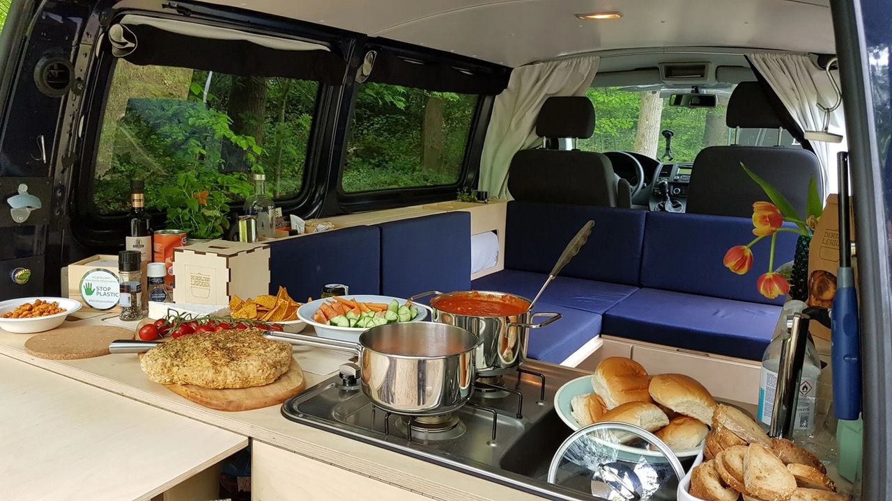 Lots of food being prepared in the VW Ventje campervan's kitchen area.