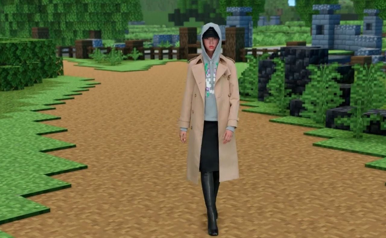 Model sports pieces from the new Burberry X Minecraft fashion collection while walking down a road rendered in the game's signature pixelated style.