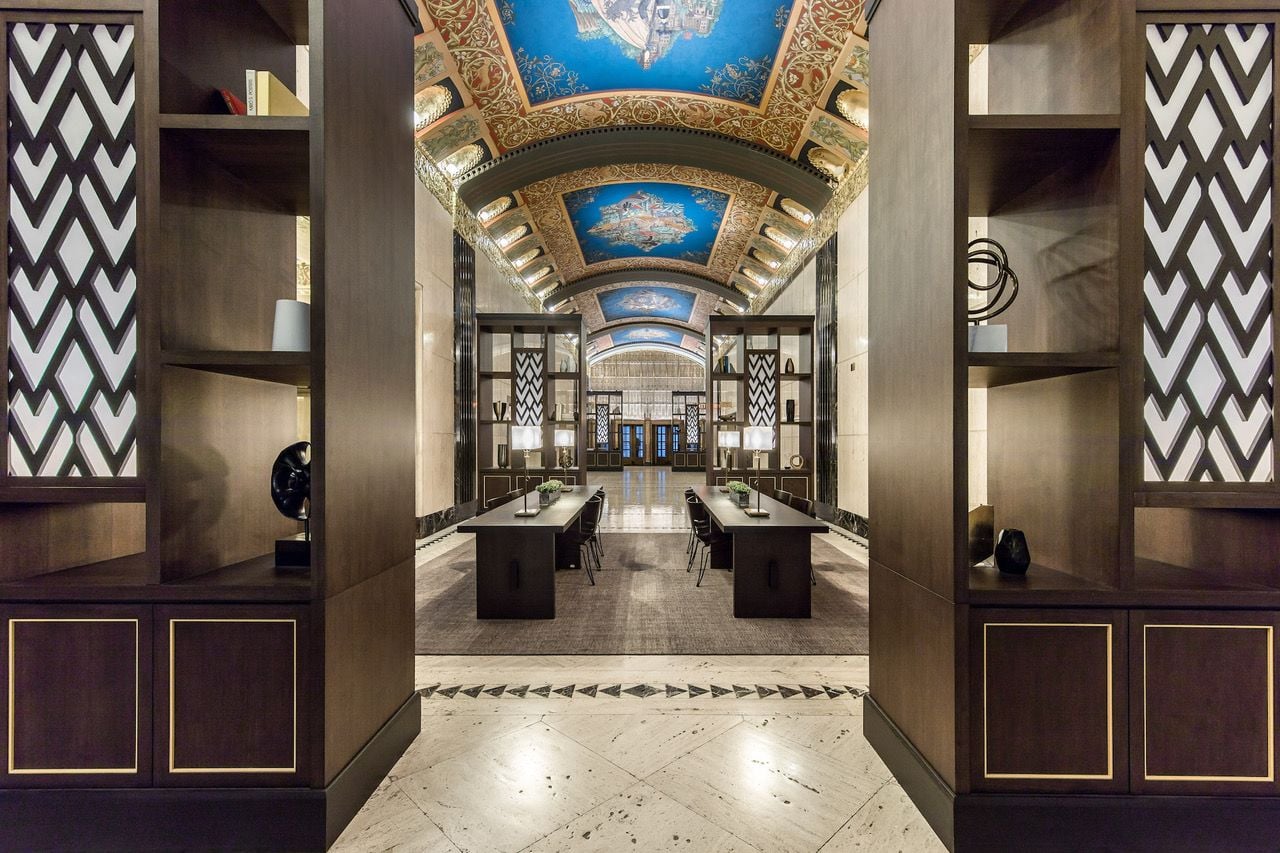 100 Barclay Street's stunning lobby filled with travertine, black marble, and frescoes depicting the dawn of telecommunications.