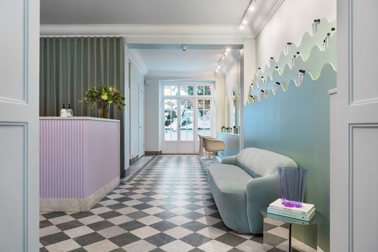 Checkered marble floors like this one contrast the salon's organic elements for a truly one-of-a-kind vibe.