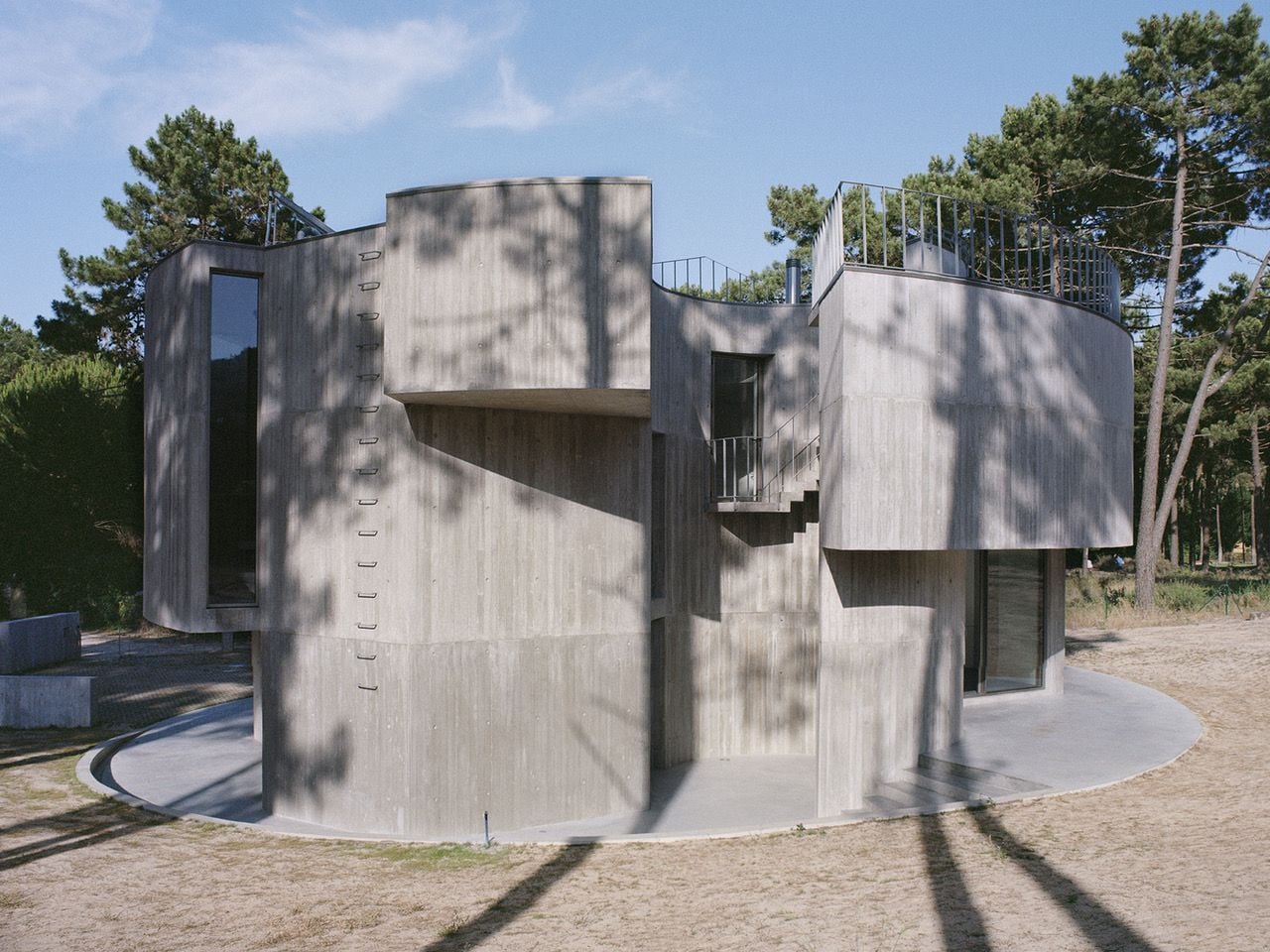 The cold concrete facade of Casa Trevo is almost labyrinthine in its appearance. 