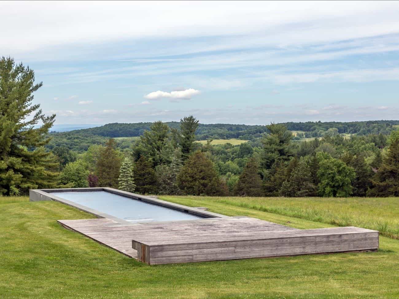 A simple concrete swimming pool graces the exterior of the Tsai Residence. 