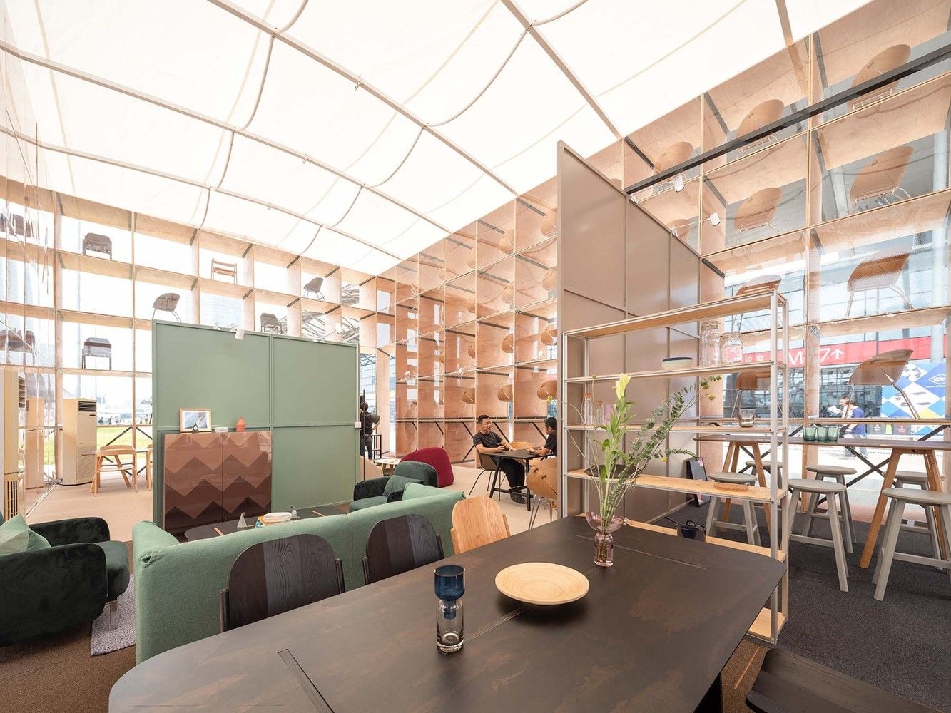 Inside the see-through pavilion, simple stylish furnishings abound.