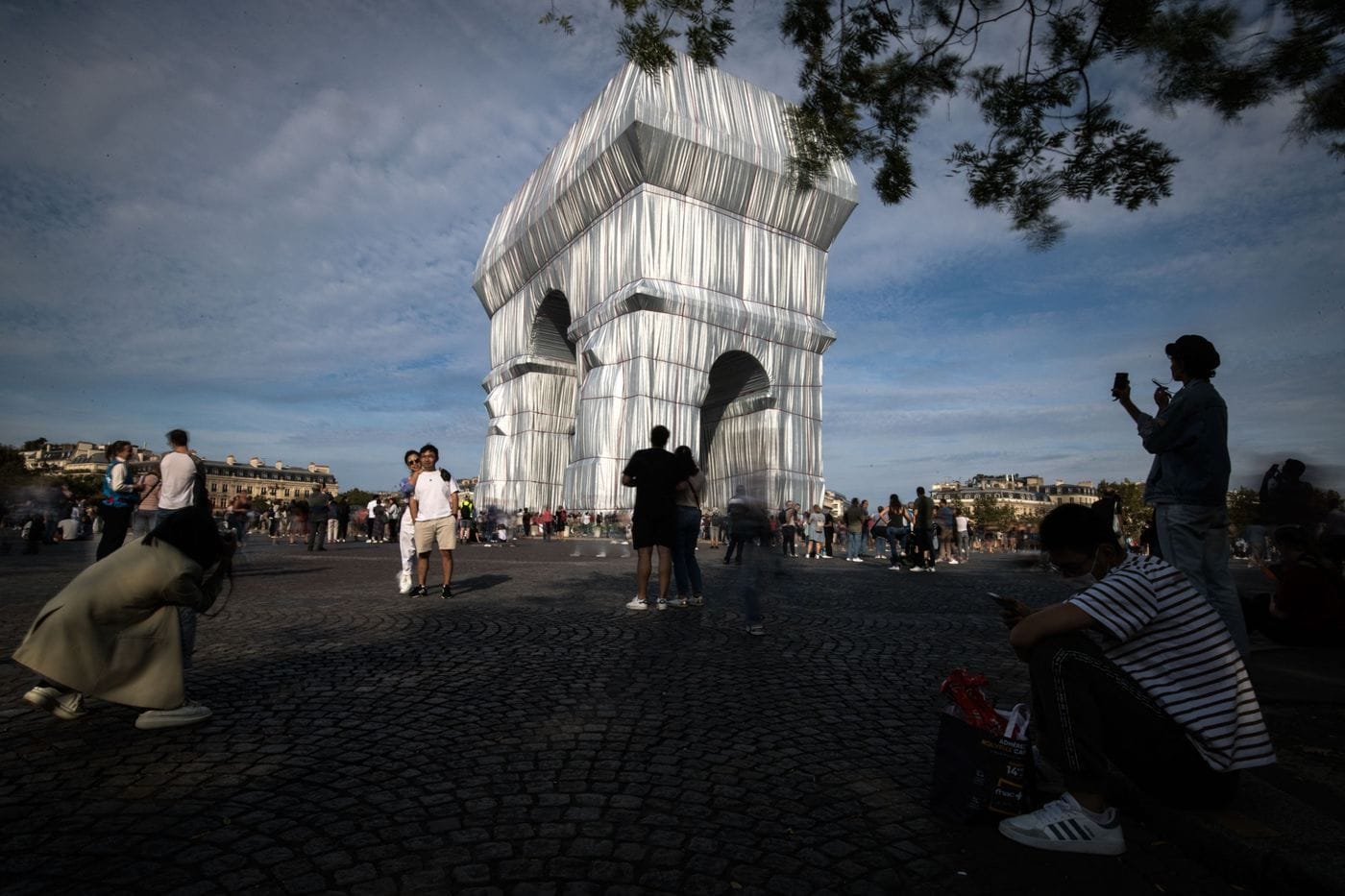 Visitors take photos of the Christo-conceived wrapped up Arc de Triomphe. 
