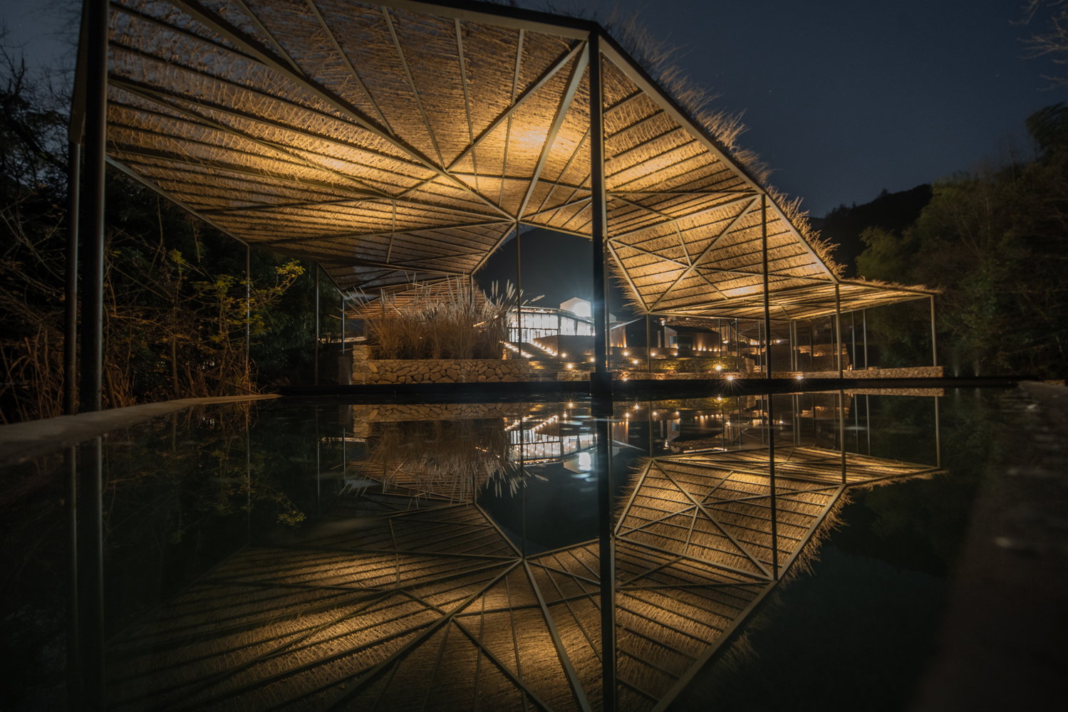 View of the Sou Fujimoto-designed Flowing Cloud pavilion at night. 