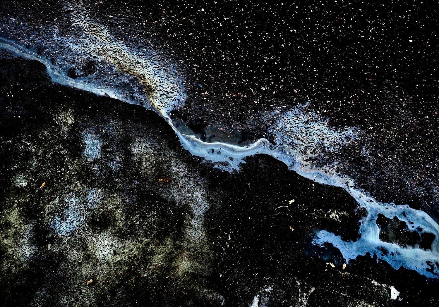 Close-up oil spill photo resembles stars and galaxies in space, as featured in photographer Juha Tanhua's ongoing 