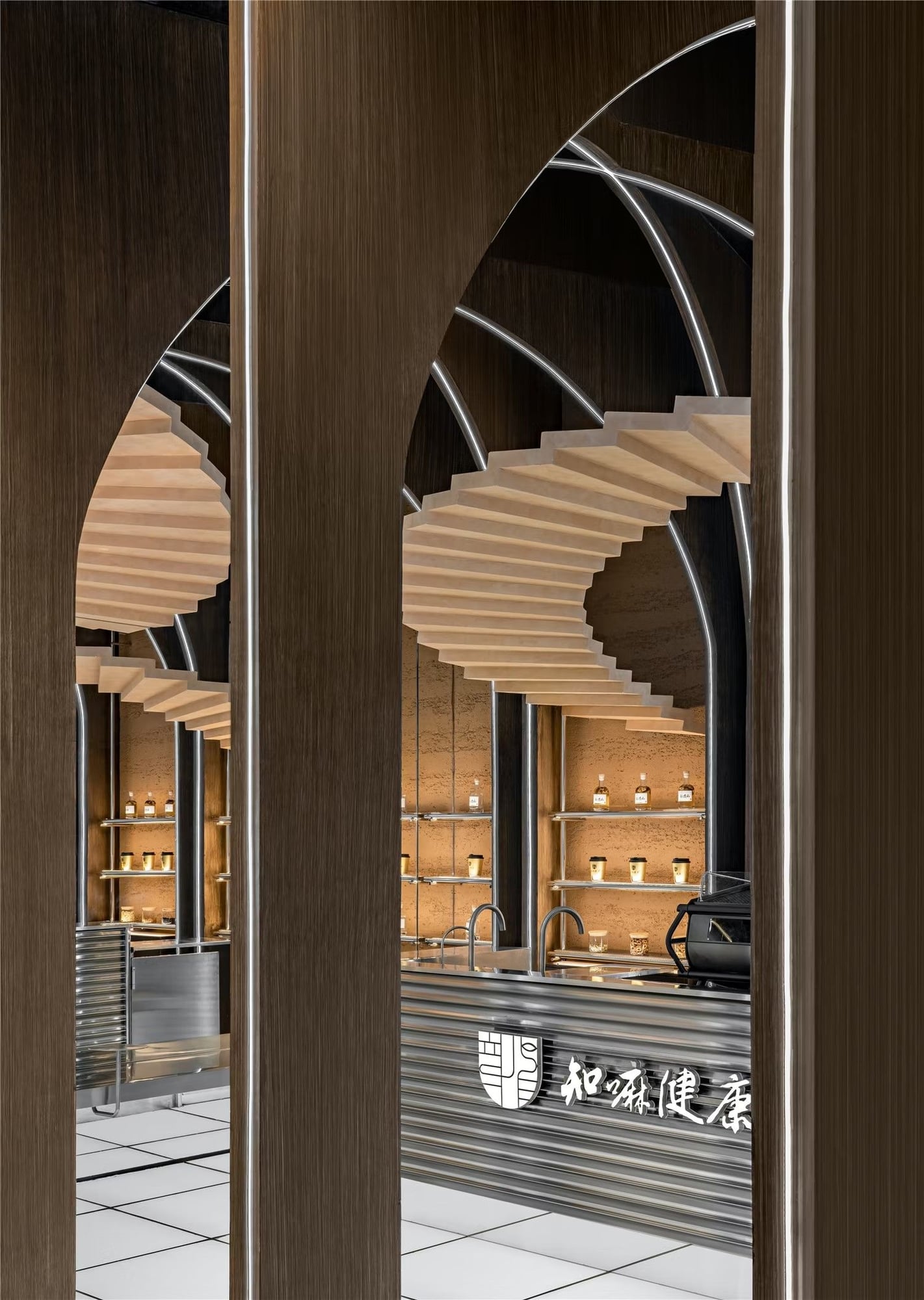 Staircase wraps through archways above the Zhima Health store's bar area.