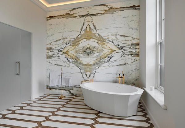 Dramatic stone backsplash in a contemporary bathroom made from Elite Stone's Calacatta Borghini Imperiale paneling.