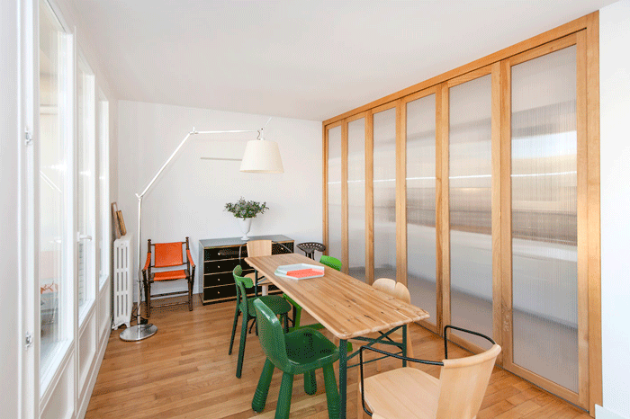A Clichy apartment renovated by Atelier Pierre Louis Gerlier, complete with white walls and translucent doors.