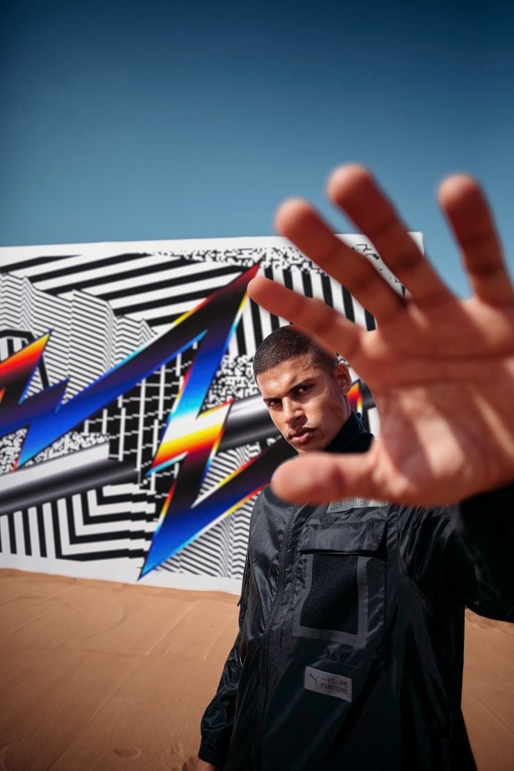 Artist Felipe Pantone stands in front of one of his creations.